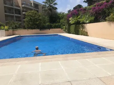 a man swimming in a swimming pool at Happyfew Sainte Anne in Nice