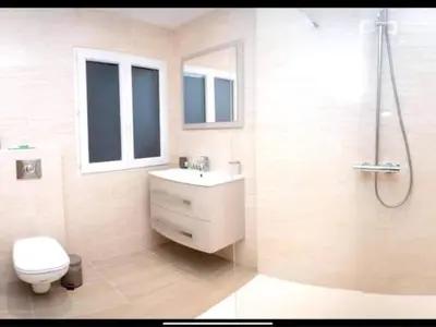 a bathroom with a toilet and a sink and a shower at Charming Apartment in Nice in Nice