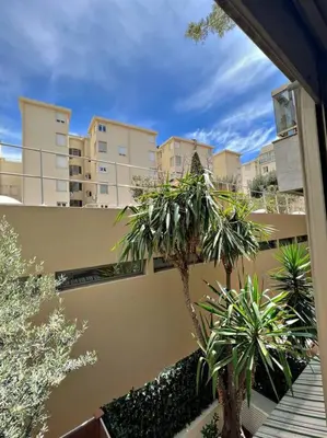 a view of a building with palm trees in a courtyard at Carré d'or Studio 2 in Nice