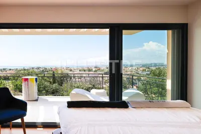 a bedroom with a bed and a large window at Villa Vue Mer, Piscine & Plage à 6Min in Cagnes-sur-Mer