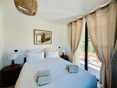 a bedroom with a bed with two pillows on it at Paisible et Spacieuse Villa avec 4 suites indépendantes in La Gaude