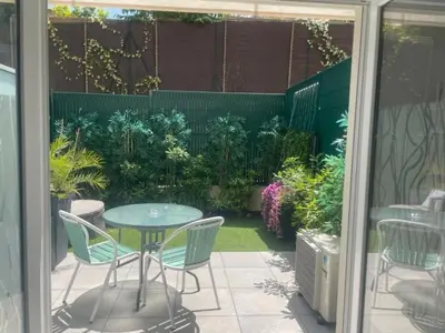 a patio with a table and chairs and plants at Chez Candie in La Trinité