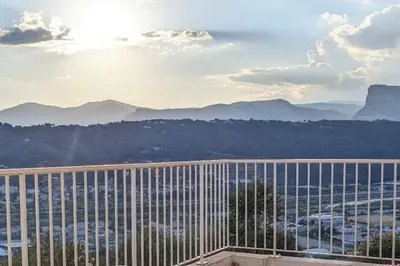 a view of the mountains from a balcony of a building at 3 pièces dans villa avec piscine in Nice
