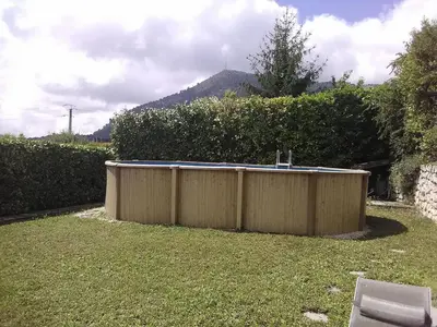a swimming pool in a yard next to a fence at VILLA DE CHARME sur la Côte d'Azur in Tourrette-Levens