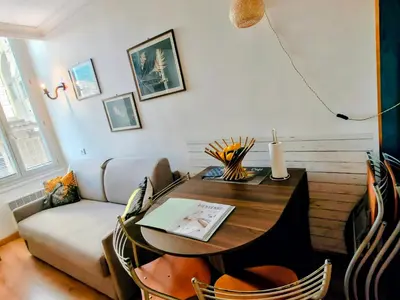 a living room with a table and a couch at Central close to beaches and shops, up till 6 pers in Nice