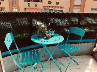 a black table and chairs in a room with a window at Studio Nice proche plages / université in Nice