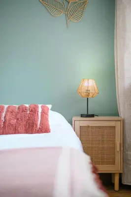 a bedroom with a bed and a lamp on a night stand at Cosy Morning - L'Azur - Plage 100mètres in Cagnes-sur-Mer