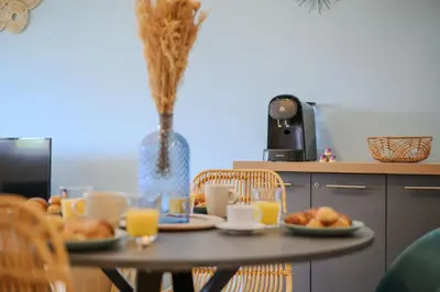 a table with plates of food on top of it at Cosy Morning - L'Azur - Plage 100mètres in Cagnes-sur-Mer