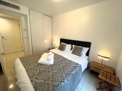 a bedroom with a large bed with towels on it at Sunlight Properties - Mirage - Central Nice with Parking and Terrace in Nice
