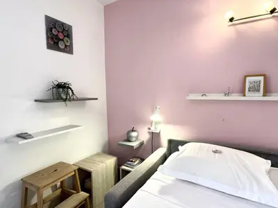 a room with a bed and a table in it at ApartHotel Riviera - MALONAT 3 - Grand Studio très calme -Old Town Promenade des Anglais in Nice