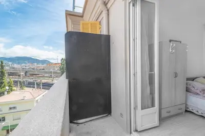 an open window on a balcony with a view of a city at Nice Charmant 2 pièces in Nice