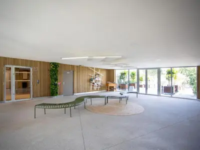 a large room with three green benches in a building at Apartment Rive de Cagnes by Interhome in Cagnes-sur-Mer