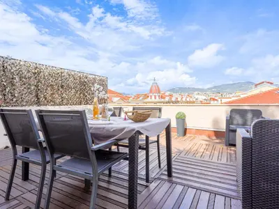 a patio with a table and chairs on a balcony at Apartment Les terrasses de l'Escurial by Interhome in Nice