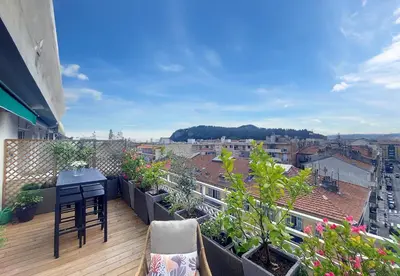 a balcony with a table and chairs on a balcony at Nestor&Jeeves - SUN DECK TERRACE - Top Floor in Nice