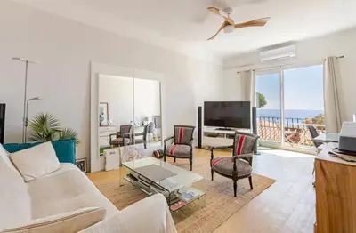 a living room with a couch and a tv at Cosy appartement, Vue Mer panoramique in Nice