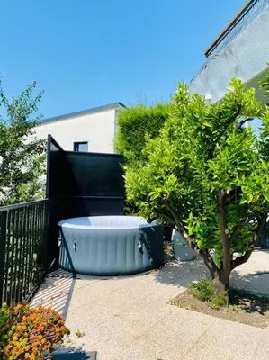 a large blue tub sitting next to a tree at Echapée Belle - Vinayard view - Jacuzzi BBQ - parking in Nice