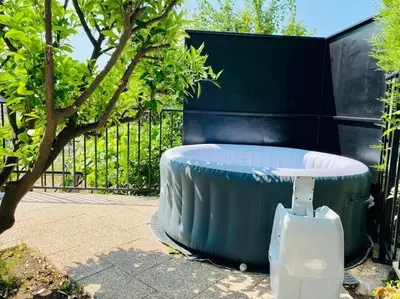 a large blue tub sitting next to a fence at Echapée Belle - Vinayard view - Jacuzzi BBQ - parking in Nice