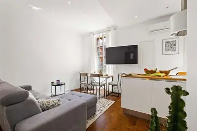 a living room with a couch and a kitchen at La Cachette du Port! -Avec parking au Port de Nice in Nice