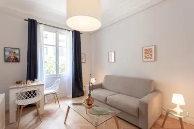 a living room with a couch and a table at 26 Nice Parc Imperial studio in Nice
