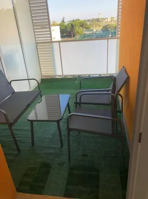 a room with three chairs and a table on a balcony at Logement neuf proche plage et aéroport in Nice