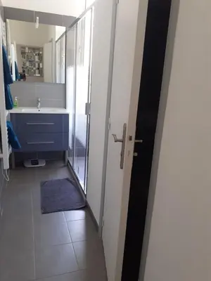 a bathroom with a shower and a sink and a mirror at 2 Pièces Neuf WIFI Quartier Borriglione in Nice