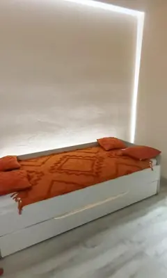 a bed in a white room with avertisementatronatronstrationstrationstrationstrationstration at Rose Garden in Cagnes-sur-Mer
