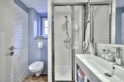 a bathroom with a shower and a sink and a toilet at La Maison Hélène & Antoine Nice Le Port in Nice