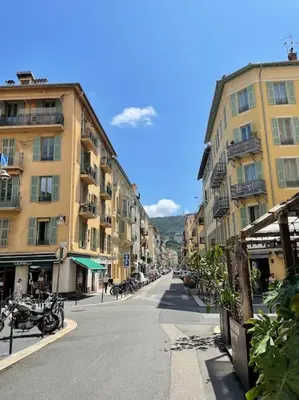 an empty street in a city with buildings at La Maison Hélène & Antoine Nice Le Port in Nice