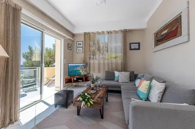 a living room with a couch and a tv at VILLA CRUG HYWEL - VILLEFRANCHE-SUR-MER in Villefranche-sur-Mer