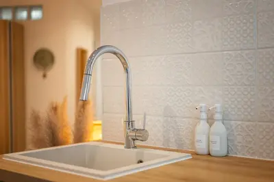 a kitchen sink with a faucet on a counter at Appartement bord de mer « La Petite Ma-Line » in Cagnes-sur-Mer