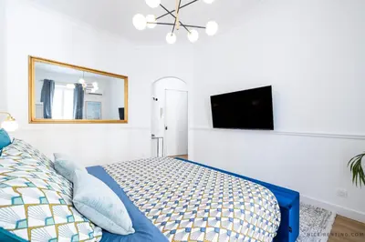 a bedroom with a bed and a flat screen tv at Nice Renting - FRANCE - Luxury Suite Palace Love Jacuzzi - Few meters from Sea in Nice