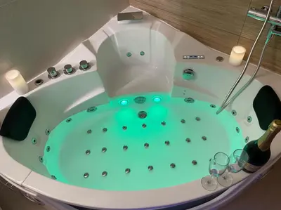 a bath tub with a blue water in it at Nice Renting - FRANCE - Luxury Suite Palace Love Jacuzzi - Few meters from Sea in Nice