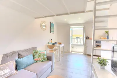 a living room with a couch and a table at #2 Central Studio top floor AC & Balcony in Nice