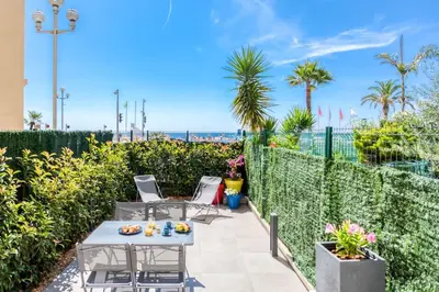 a patio with a table and chairs and the beach at #43 Design Studio Terrace AC Wifi Sea View 1min Beach in Nice