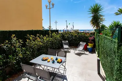 a patio with chairs and a table with food on it at #43 Design Studio Terrace AC Wifi Sea View 1min Beach in Nice