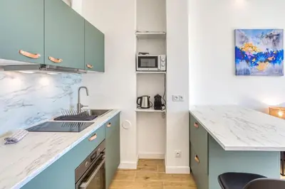 a kitchen with blue cabinets and a counter top at #43 Design Studio Terrace AC Wifi Sea View 1min Beach in Nice