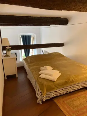 a bedroom with a bed with towels on it at Apartment 33 on The Old Historic Senate Square in Nice