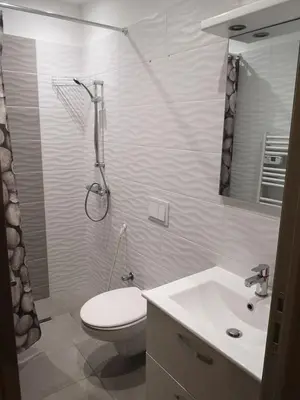 a bathroom with a toilet and a sink and a shower at maison de papa in Nice