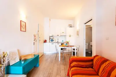 a living room with a couch and a table at LA RESERVE AP4369 By Riviera Holiday Homes in Villefranche-sur-Mer