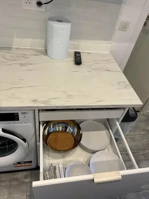 a kitchen counter with a bowl in a drawer at Chambre promenade des anglais in Nice