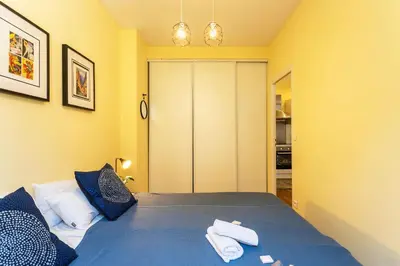 a bedroom with a blue bed with towels on it at LE ST FRANCOIS AP4368 By Riviera Holiday Homes in Nice
