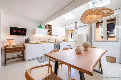 a kitchen and dining room with a wooden table and chairs at Nice Renting - NEUVE - Luxury Triplex Old Town Massena Garibaldi - 4 BedRoom - AC in Nice
