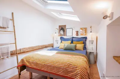 a bedroom with a bed with blue and yellow pillows at Nice Renting - NEUVE - Luxury Triplex Old Town Massena Garibaldi - 4 BedRoom - AC in Nice