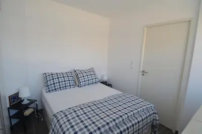 a small bedroom with a bed with a plaid blanket at VILLA SMOLETT - Appartement Cosy au cœur du quartier du port in Nice