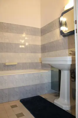 a bathroom with a sink and a bath tub at Le Grand Sud in Nice