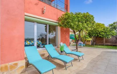 a group of blue chairs sitting outside of a building at Nice Home In Saint-Laurent-Du-Var in Saint-Laurent-du-Var