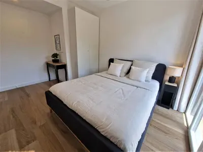 a bedroom with a large bed with white sheets and pillows at The Chic Libération in Nice