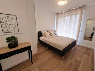 a small bedroom with a bed and a window at The Chic Libération in Nice