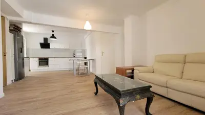 a living room with a couch and a coffee table at appartement neuf de 3 pieces avec climatisation in Nice