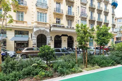 a building with cars parked in front of it at Large Haussmanian appartment in the heart of Nice in Nice